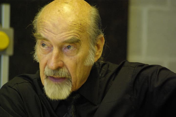 Close-up of Bernhard Banaschewski in a black shirt, mid-conversation