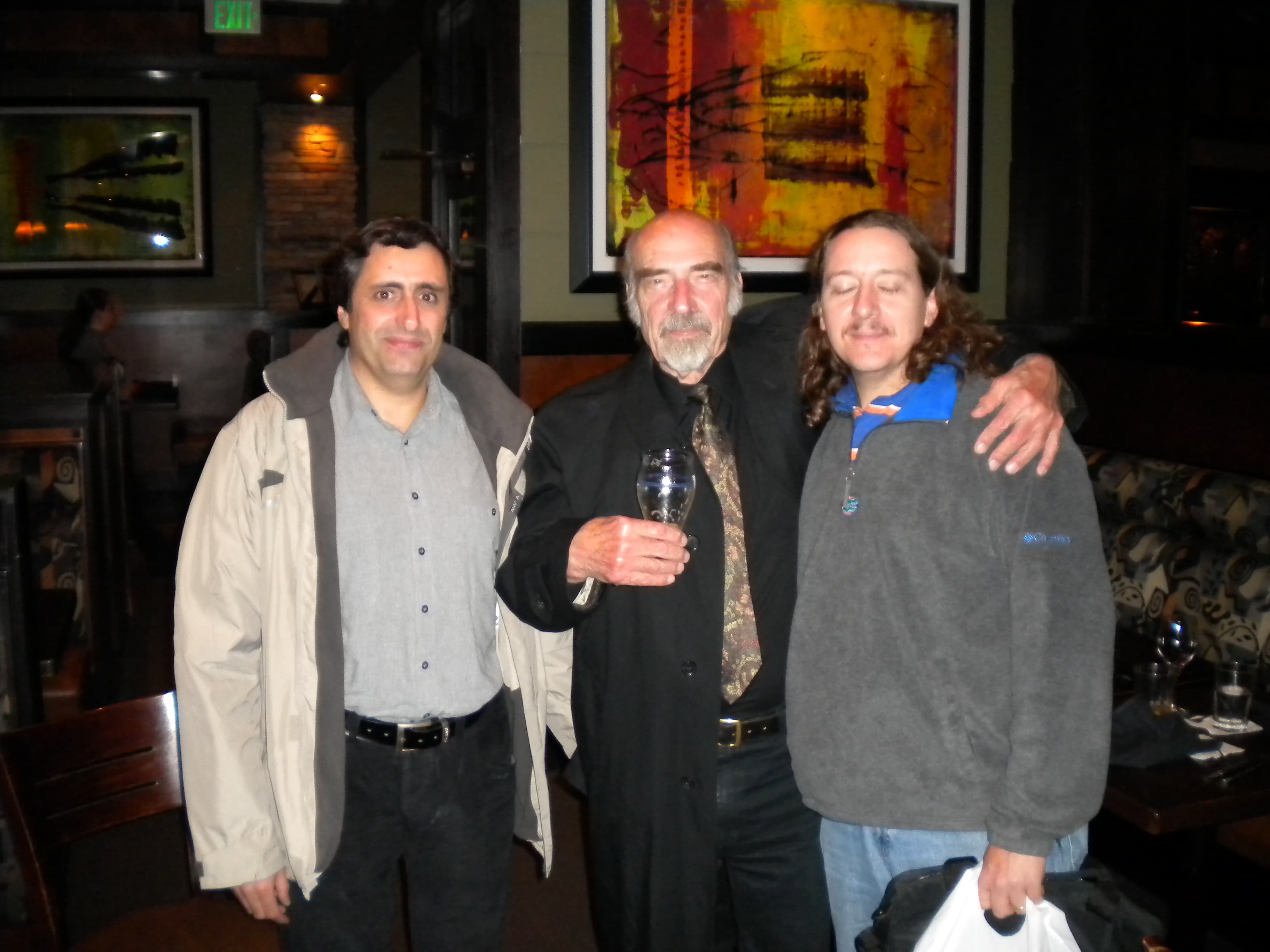 Bernhard Banaschewski, glass in hand, standing between two younger colleagues